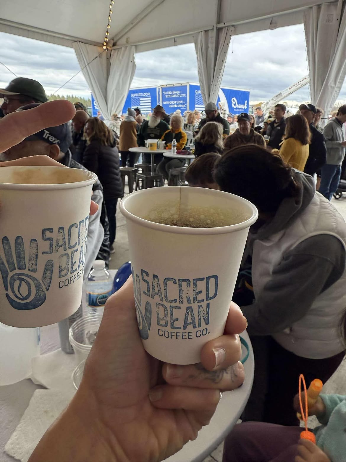 Cheers with Sacred Bean cups at the Drexel grand opening